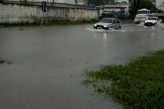 eunapolis, bahia / brazil - april 9, 2009: vehicle transits in flooded area on highway BR 101 in the city of Eunapolis, in southern Bahia..
