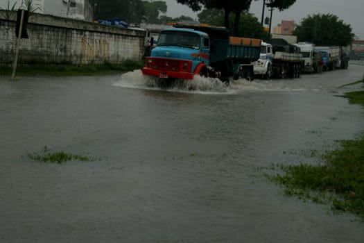 eunapolis, bahia / brazil - april 9, 2009: vehicle transits in flooded area on highway BR 101 in the city of Eunapolis, in southern Bahia..