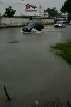 eunapolis, bahia / brazil - april 9, 2009: vehicle transits in flooded area on highway BR 101 in the city of Eunapolis, in southern Bahia..