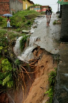 eunapolis, bahia / brazil - april 9, 2009: crater caused by soil erosion is seen on the street in the city of Eupolis, in southern Bahia.