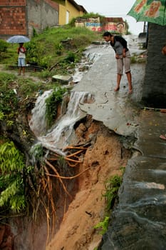 eunapolis, bahia / brazil - april 9, 2009: crater caused by soil erosion is seen on the street in the city of Eupolis, in southern Bahia.