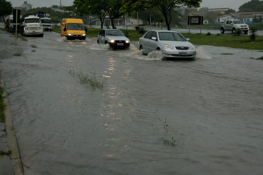 eunapolis, bahia / brazil - april 9, 2009: vehicle transits in flooded area on highway BR 101 in the city of Eunapolis, in southern Bahia..