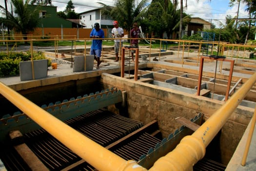 eunapolis, bahia / brazil - february 1, 2009: workers work to clean Embasa's water treatment plant in the city of Eunapolis.