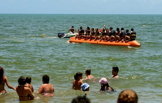 porto seguro, bahia / brazil - january 8, 2009: People are seen aboard a vessel known as a banana boat on the beach in the city of Porto Seguro.