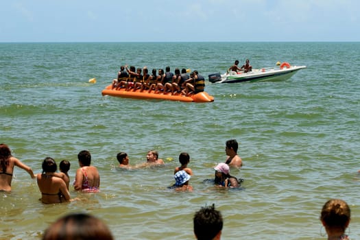 porto seguro, bahia / brazil - january 8, 2009: People are seen aboard a vessel known as a banana boat on the beach in the city of Porto Seguro.