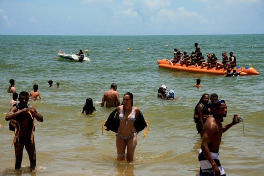 porto seguro, bahia / brazil - january 8, 2009: People are seen aboard a vessel known as a banana boat on the beach in the city of Porto Seguro.