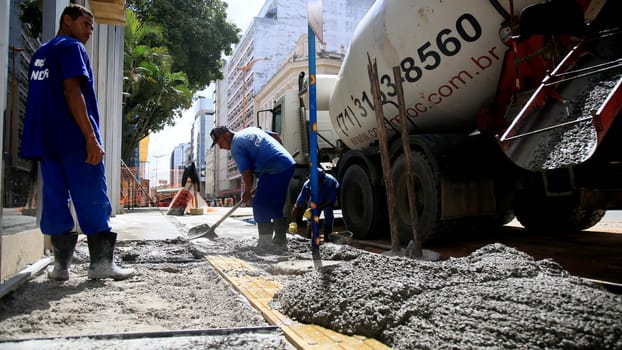 salvador, bahia / brazil - september 8, 2020: bricklayers work on the construction of a sidewalk in the neighborhood of Comercio in the city of Salvador.