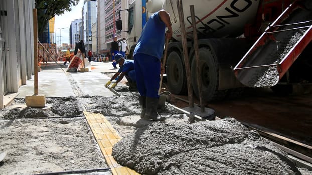 salvador, bahia / brazil - september 8, 2020: bricklayers work on the construction of a sidewalk in the neighborhood of Comercio in the city of Salvador.