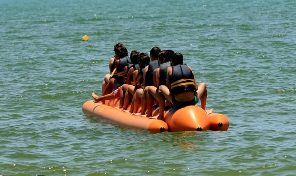 porto seguro, bahia / brazil - january 8, 2009: People are seen aboard a vessel known as a banana boat on the beach in the city of Porto Seguro.