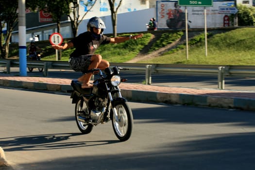 eunapolis, bahia / brazil - january 15, 2009: motocilcista is seen standing while the vehicle is traveling on the BR 101 highway in the city of Eunapolis.