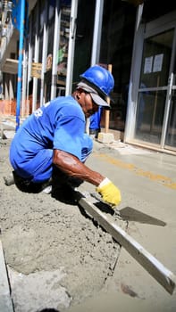 salvador, bahia / brazil - september 8, 2020: bricklayers work on the construction of a sidewalk in the neighborhood of Comercio in the city of Salvador.