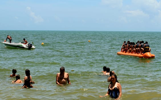 porto seguro, bahia / brazil - january 8, 2009: People are seen aboard a vessel known as a banana boat on the beach in the city of Porto Seguro.