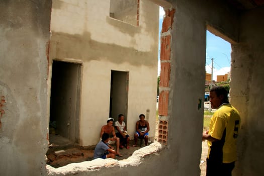 eunapolis, bahia / brazil - january 15, 2009: people who are members of the Association Residents Without a Roof are seen during the invasion of houses under construction, aimed at poor families in the city of Eunapolis....