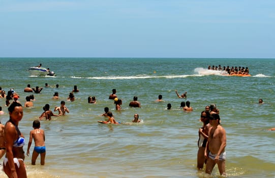 porto seguro, bahia / brazil - january 8, 2009: People are seen aboard a vessel known as a banana boat on the beach in the city of Porto Seguro.