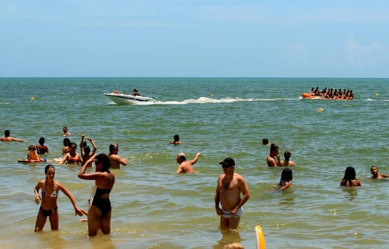 porto seguro, bahia / brazil - january 8, 2009: People are seen aboard a vessel known as a banana boat on the beach in the city of Porto Seguro.
