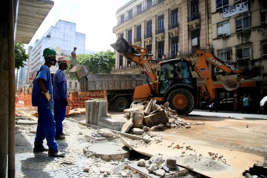 salvador, bahia / brazil - september 8, 2020: backhoe trablah collecting rubble from sidewalk contraction in the neighborhood of Comercio in the city of Salvador.