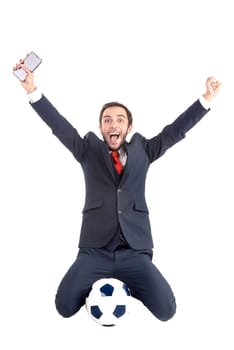 Happy businessman with soccer ball and phone posing isolated in white