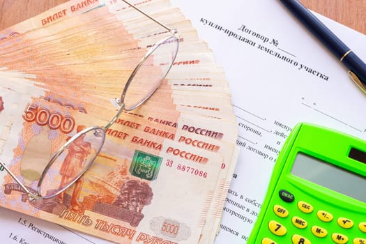 Signing a purchase and sale agreement for a land plot and payment