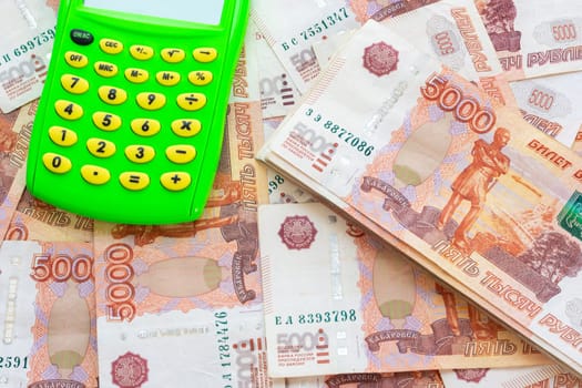 A pile of five thousandth Russian bills and a calculator