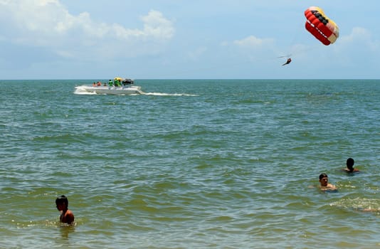 porto seguro, bahia / brasil - 8 de janeiro de 2009: pessoa é vista utilizando parasail - paraquedas puxado por barco - na praia da cidade de Porto Seguro..