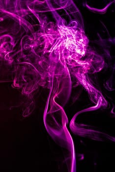 Violet abstract shaped smoke against black background. Abstract background. Selective focus