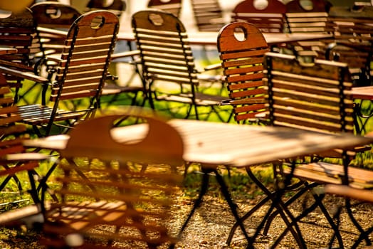 empty chairs and desks of a garden restaurant