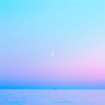 Cloudless pink and blue sky with a crescent moon reflected in the water surface in the White Nights season. Abstract square blurred background of calm seascape with copy space. Lake Onega, Russia.