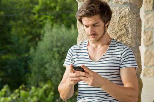 young casual man on the phone, outdoor