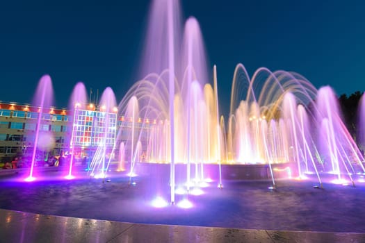 Anapa, Russia - July 17, 2020: View of a large beautiful multi-colored fountain in front of the city administration building of the Anapa resort