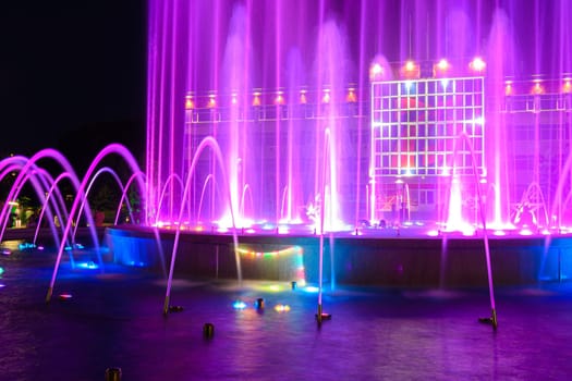 Anapa, Russia - July 17, 2020: Fragment of a beautiful multi-colored fountain against the background of the building of the city administration of the Anapa resort