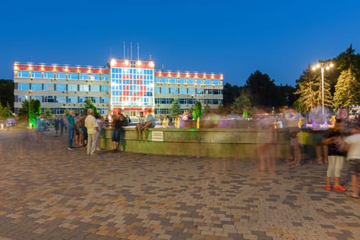 Anapa, Russia - July 17, 2020: A crowd of tourists on one of the main attractions of the city of the resort of Anapa, Soviets Square in front of the city administration