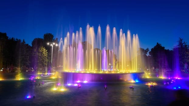 Anapa, Russia - July 17, 2020: A beautiful fountain against the background of a dark sky, located in the resort town of Anapa