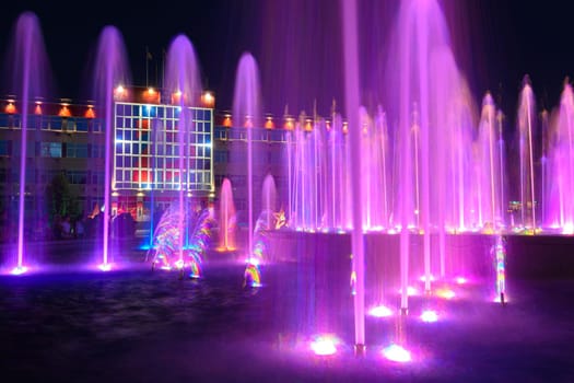 Anapa, Russia - July 17, 2020: The jets of a large fountain, in the background the building of the administration of the city of the resort of Anapa