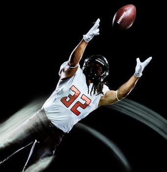 one african american football player man studio shot isolated on black background with light painting with blurred motion speed effect