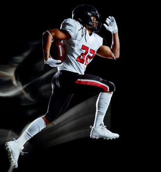one african american football player man studio shot isolated on black background with light painting with blurred motion speed effect