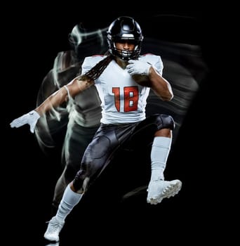 one african american football player man studio shot isolated on black background with light painting with blurred motion speed effect