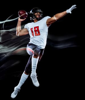 one african american football player man studio shot isolated on black background with light painting with blurred motion speed effect