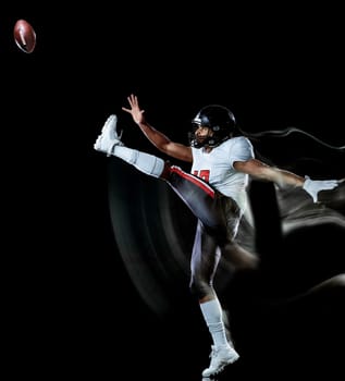 one african american football player man studio shot isolated on black background with light painting with blurred motion speed effect