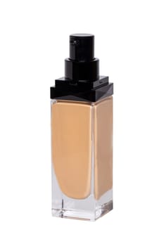 Cosmetic foundation isolated. Close-up of an open glass bottle with liquid skin foundation isolated on a white background. Makeup concept of moisturiser and toner creme. Macro.