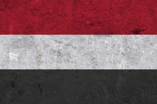Flag of Yemen on weathered concrete
