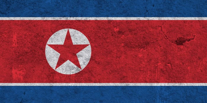 Flag of North Korea on weathered concrete