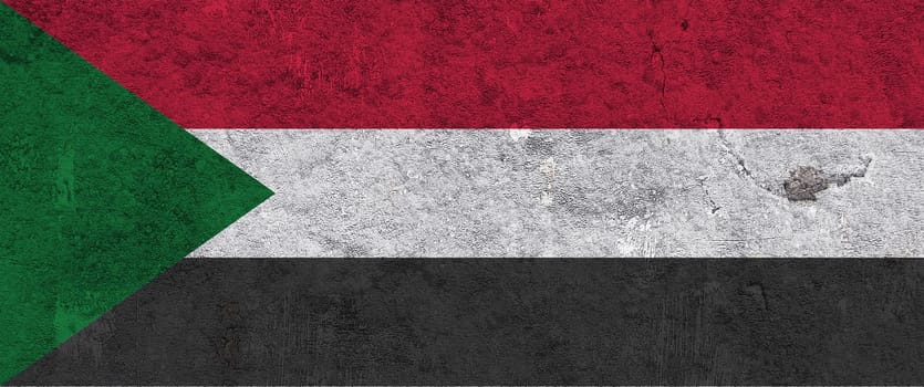 Flag of Sudan on weathered concrete