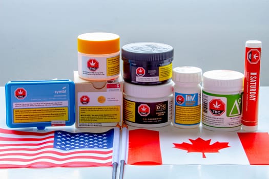 Calgary, Alberta, Canada. Sep 18, 2020. Canadian legal cannabis popular brands of marijuana weed with USA and Canada flag.