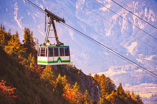 Tegelberg Cable Car in Bavaria, near Fussen, Germany, Europe. Mountain slope in foreground with trees and distant mountains in background
