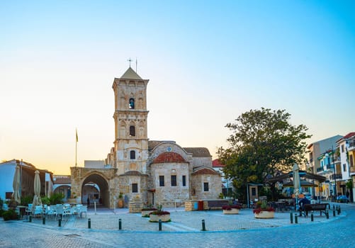 Saint Lazarus church at Larnaka square in evening light, cafes and shops at tiusristic street, Cyprus
