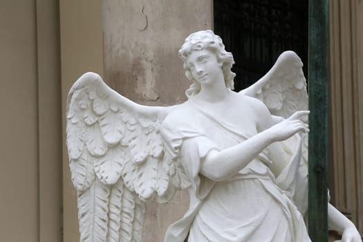 Angel statue in front of Karlskirche church in Vienna, Austria