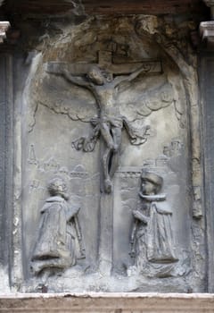 An old crucifixion relief sculpture outside St. Stephen's Cathedral in Vienna, Austria