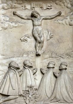 An old crucifixion relief sculpture outside St. Stephen's Cathedral in Vienna, Austria