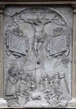 An old crucifixion relief sculpture outside St. Stephen's Cathedral in Vienna, Austria