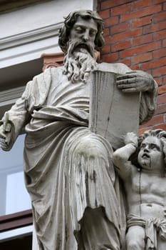 Saint Matthew the Evangelist on the facade of Evangelical School in Vienna, Austria